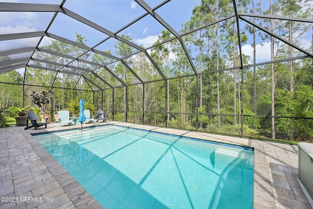 outdoor pool featuring a patio area and glass enclosure