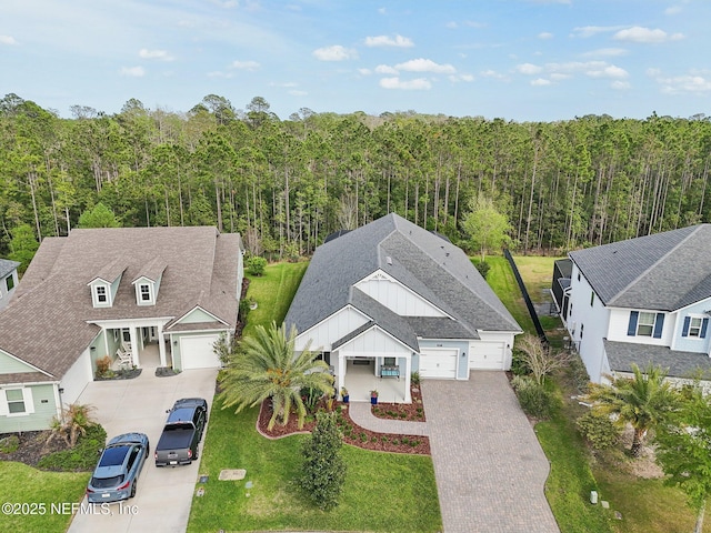 birds eye view of property with a forest view