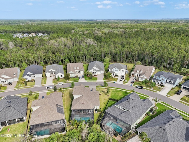 bird's eye view featuring a view of trees and a residential view