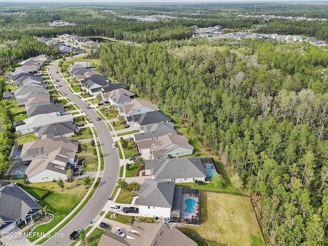 birds eye view of property with a forest view and a residential view