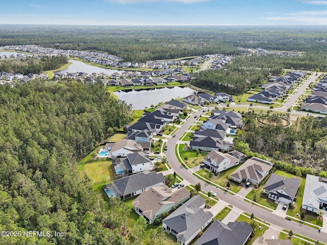 aerial view featuring a view of trees, a residential view, and a water view