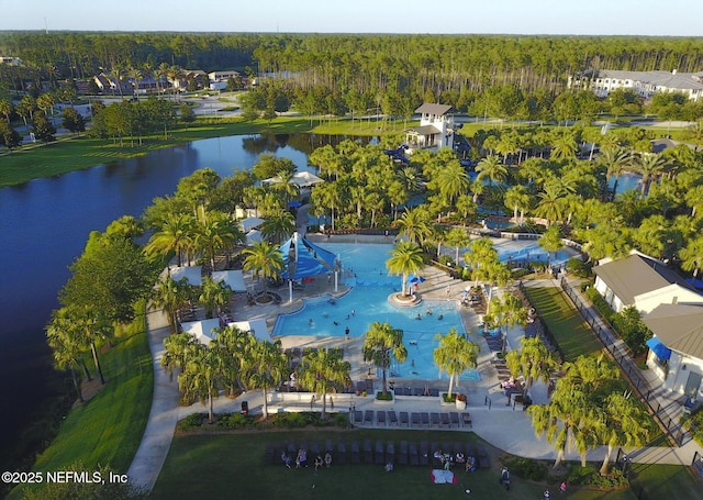 birds eye view of property featuring a water view and a wooded view