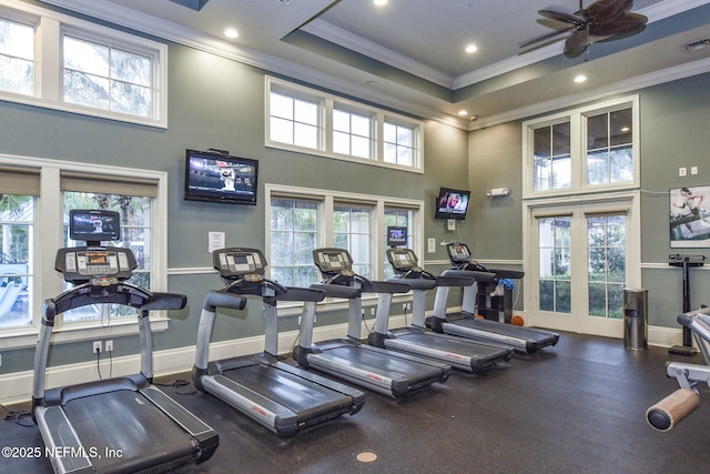 exercise room featuring a ceiling fan, baseboards, and ornamental molding