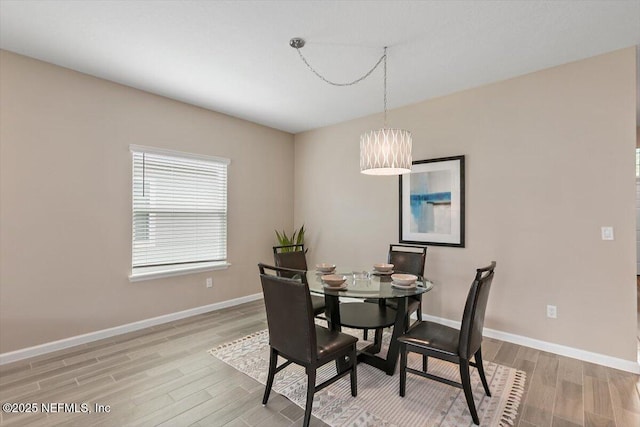 270 King George Ave, Saint Augustine, FL 32092 - dining room with a chandelier, light wood-style floors, and baseboards