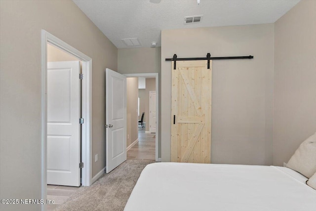 270 King George Ave, Saint Augustine, FL 32092 - bedroom with light colored carpet, baseboards, visible vents, and a barn door