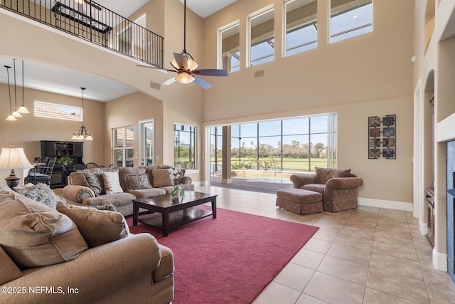9 Cypresswood Dr, Palm Coast, FL 32137 - living room with visible vents, baseboards, a ceiling fan, arched walkways, and light tile patterned floors