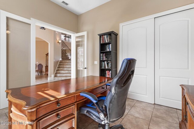 9 Cypresswood Dr, Palm Coast, FL 32137 - home office featuring arched walkways, visible vents, and light tile patterned floors