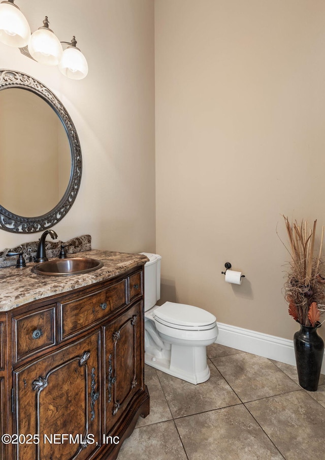 9 Cypresswood Dr, Palm Coast, FL 32137 - bathroom featuring tile patterned floors, toilet, vanity, and baseboards
