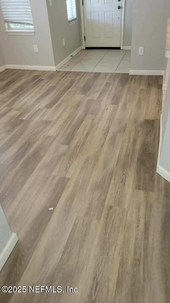 8550 Argyle Business Loop Unit 1308, Jacksonville, FL 32244 - entrance foyer featuring baseboards, light wood finished floors, and healthy amount of natural light