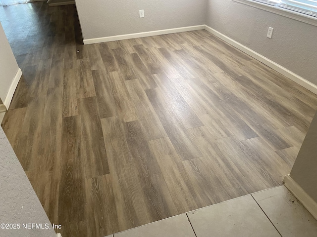 8550 Argyle Business Loop Unit 1308, Jacksonville, FL 32244 - detailed view of baseboards, wood finished floors, and a textured wall