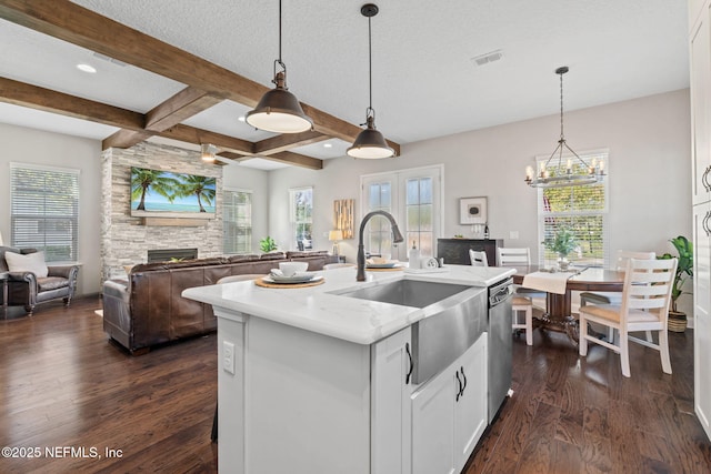 211 Bronson Pkwy, Saint Augustine, FL 32095 - kitchen with dark wood-style flooring, white cabinets, beam ceiling, a sink, and light stone counters
