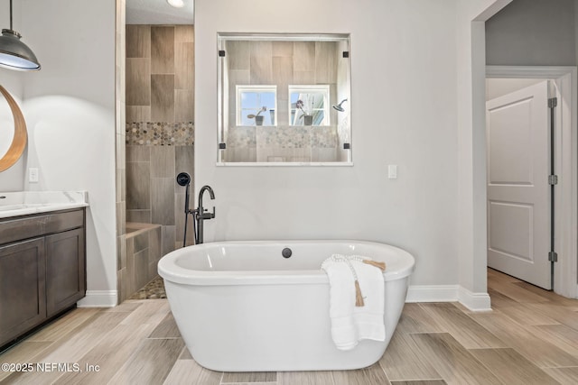 211 Bronson Pkwy, Saint Augustine, FL 32095 - full bath with a freestanding tub, wood tiled floor, a walk in shower, and vanity
