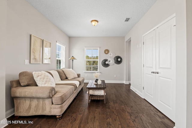211 Bronson Pkwy, Saint Augustine, FL 32095 - living area featuring baseboards, a textured ceiling, visible vents, and dark wood finished floors