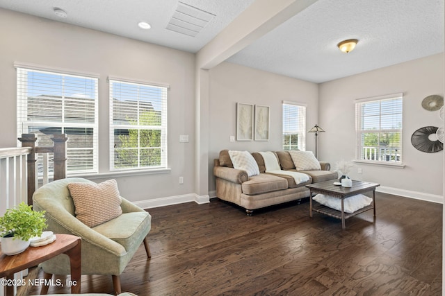 211 Bronson Pkwy, Saint Augustine, FL 32095 - living area with visible vents, dark wood-type flooring, baseboards, and a textured ceiling