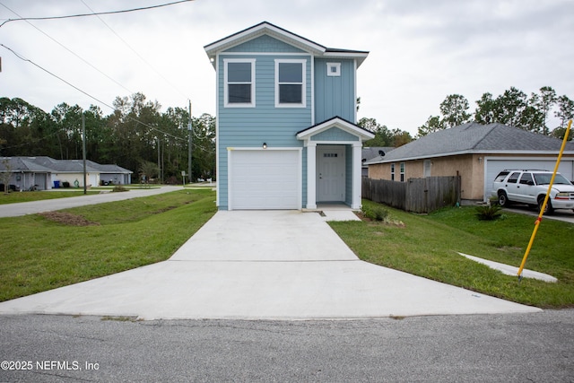 traditional-style house with a front lawn, fence, driveway, and an attached garage