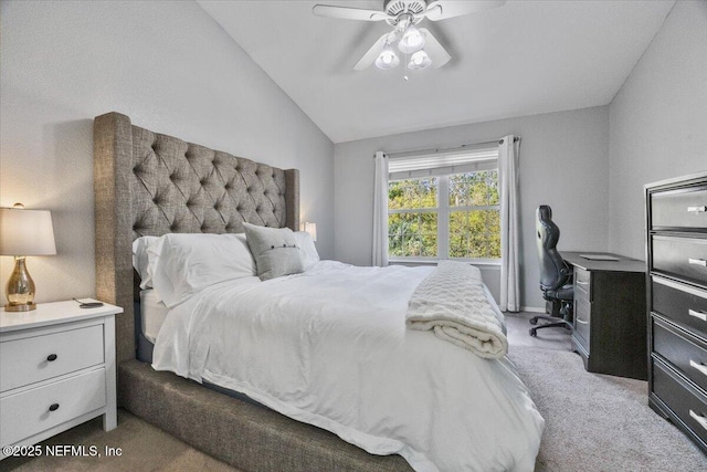 carpeted bedroom featuring vaulted ceiling and a ceiling fan