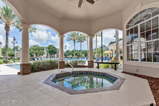 view of pool with a hot tub, a patio, and a ceiling fan