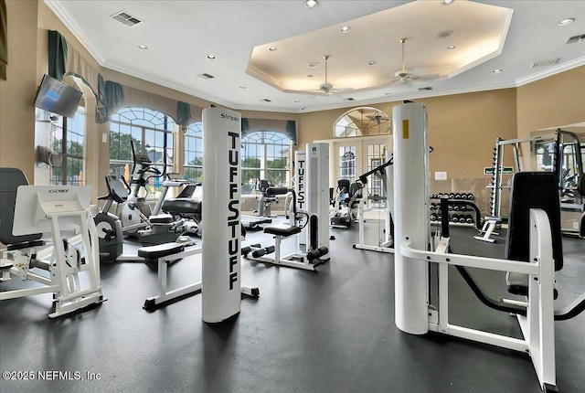workout area featuring visible vents, ornamental molding, recessed lighting, a ceiling fan, and a tray ceiling