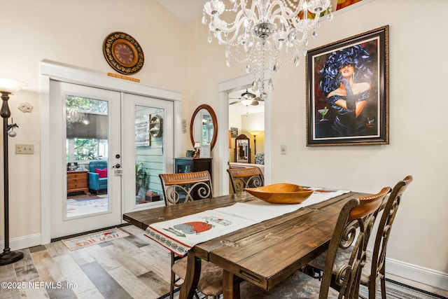 dining space featuring baseboards, a notable chandelier, light wood-style flooring, and french doors