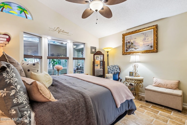 bedroom with baseboards, a textured ceiling, vaulted ceiling, and a ceiling fan