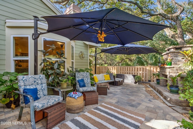 view of patio with outdoor lounge area and fence
