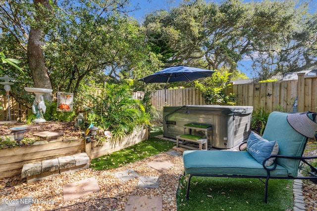 view of yard with a fenced backyard and a hot tub