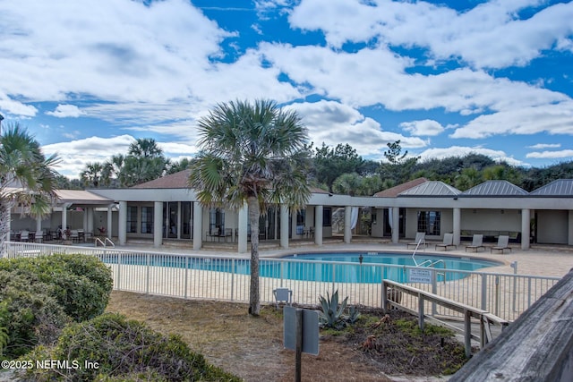 pool featuring fence and a patio area