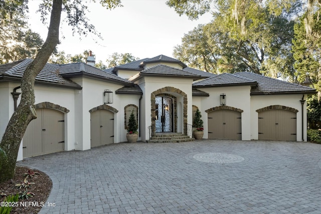 113 Cutter Ct, Ponte Vedra Beach, FL 32082 - view of front of property with curved driveway, an attached garage, stucco siding, and a tiled roof