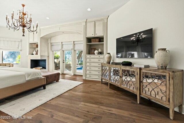 113 Cutter Ct, Ponte Vedra Beach, FL 32082 - bedroom featuring access to outside, dark wood finished floors, a notable chandelier, and multiple windows
