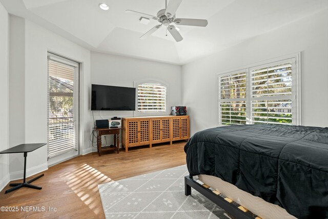 113 Cutter Ct, Ponte Vedra Beach, FL 32082 - bedroom with multiple windows, a tray ceiling, and wood finished floors