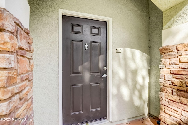 8539 Gate Pkwy W Unit 1121, Jacksonville, FL 32216 - doorway to property with stucco siding