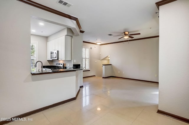 8539 Gate Pkwy W Unit 1121, Jacksonville, FL 32216 - kitchen with a ceiling fan, dark countertops, stainless steel appliances, and a wealth of natural light