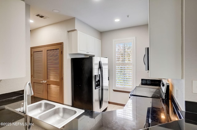 8539 Gate Pkwy W Unit 1121, Jacksonville, FL 32216 - kitchen featuring stainless steel fridge with ice dispenser, range with electric stovetop, a sink, visible vents, and white cabinets