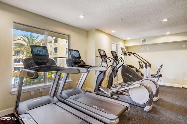 8539 Gate Pkwy W Unit 1121, Jacksonville, FL 32216 - workout area with baseboards, a textured ceiling, visible vents, and plenty of natural light