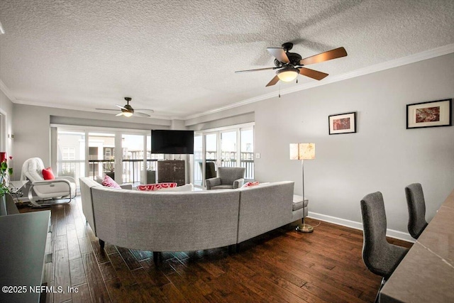living room with dark wood finished floors, crown molding, and a ceiling fan