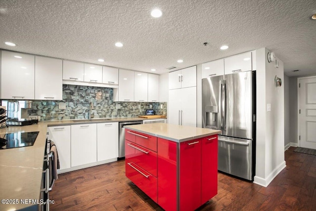 kitchen featuring dark wood-type flooring, white cabinetry, modern cabinets, and appliances with stainless steel finishes