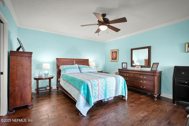 bedroom featuring a ceiling fan, a textured ceiling, baseboards, ornamental molding, and dark wood-style flooring
