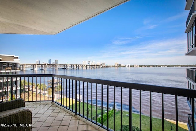 balcony with a water view and a city view