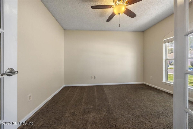carpeted spare room with baseboards, ceiling fan, and a textured ceiling