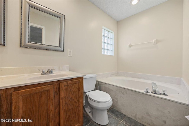 bathroom featuring a textured ceiling, a bath, tile patterned flooring, vanity, and toilet