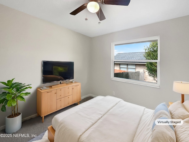 bedroom with a ceiling fan, carpet floors, and baseboards