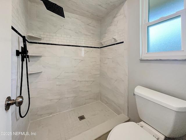 full bathroom featuring toilet and tiled shower