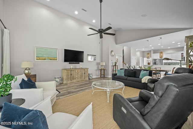 living room featuring recessed lighting, light wood finished floors, ceiling fan, and lofted ceiling