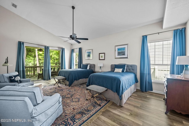 bedroom with access to outside, visible vents, multiple windows, and wood finished floors