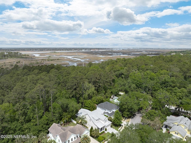 drone / aerial view with a forest view and a residential view
