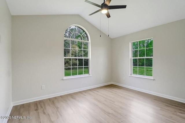 empty room with a ceiling fan, lofted ceiling, and wood finished floors