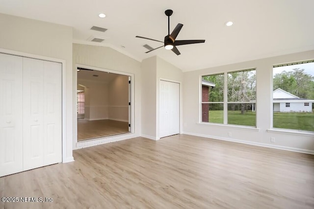 unfurnished bedroom with wood finished floors, multiple closets, lofted ceiling, visible vents, and recessed lighting