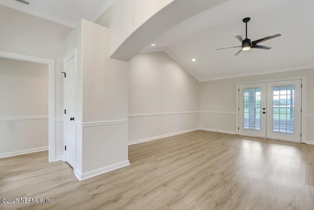 unfurnished room featuring lofted ceiling, french doors, baseboards, a ceiling fan, and wood finished floors
