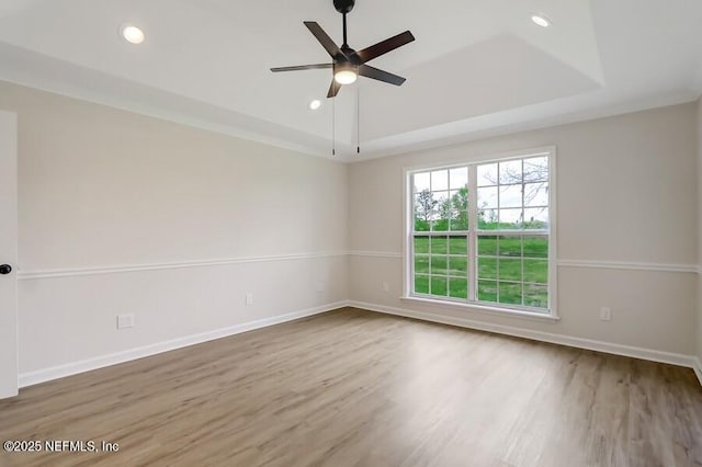 spare room with baseboards, wood finished floors, recessed lighting, and a ceiling fan