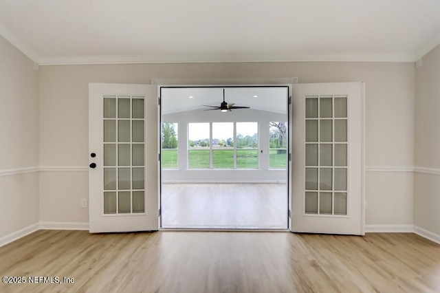 entryway with baseboards, ornamental molding, and wood finished floors